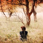 girl-and-boy-sitting-outside-away-from-each-other
