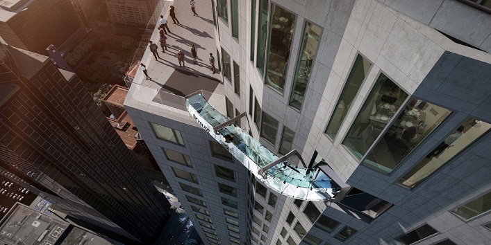 This undated artist's rendering provided by Overseas Union Enterprise Limited shows a glass slide 1,000 feet above the ground off the side of the U.S. Bank Tower in downtown Los Angeles. The 45-foot-long attraction is part of a $50 million renovation that will also put a bar and open-air observation deck on the top floors of the 72-story building. (Michael Ludvik/OUE Ltd. via AP)