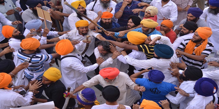 Sikh activists clash with members of the Shiromani Gurudwara Prabhandak Committee ( SGPC) during commemorations for the 30th anniversary of Operation Blue Star at the Golden Temple in Amritsar on June 6, 2014. Clashes broke out between sword-wielding Sikhs at the Golden Temple in northern India on the 30th anniversary of a notorious army raid on the site. At least two people were wounded in the violence at the temple in the city of Amritsar, which is the holiest shrine in the Sikh religion. Hundreds of Sikhs had gathered at the shrine to pay their respects to those killed in the June 6 1984 raid of the temple by Indian troops aimed at flushing out armed separatists demanding an independent Sikh homeland. AFP PHOTO/NARINDER NANU (Photo credit should read NARINDER NANU/AFP/Getty Images)