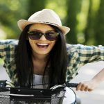 Happy young woman with bicycle