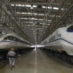 File photo of a worker walking between two bullet trains at a high speed railway maintenance station in Xi’an