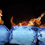 Burning ice cubes on black background